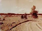 Axbergs kyrka, exteriör.
Landskapsbild med kyrkan i bakgrunden.
Beställningsnr: AG-150, 250.