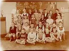 Klassrumsinteriör, skolbarn med lärarinna.
Sam Lindskogs familjebild.