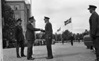 Kungen I3 28 augusti 1967

Kung Gustav VI Adolf besöker Örebro Livregementes Grenadjärer i Grenadjärsstaden. Kungen samtalar med militärer och hälsar på en av dem som han tar i hand. Alla är klädda i militäruniformer. I bakgrunden syns publik som tittar på.