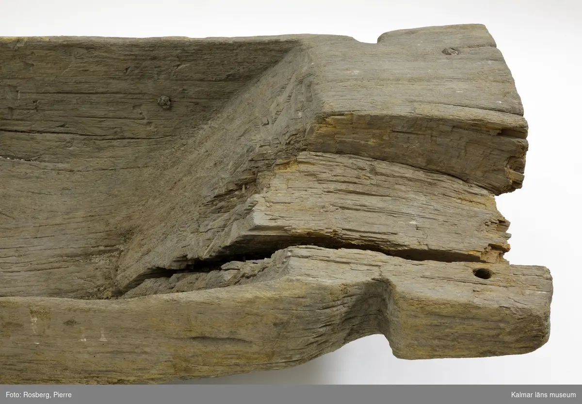 KLM 45113. Båt, stockbåt. Av stor urholkad trädstam, krokig med många knaggar. Huggen i ett stycke. Stamrunt tvärsnitt med runt fallande överhäng. Har tre kraftiga tofter eller skott utsparade i stocken. Går ej att urskilja för respektive akter, eventuellt är den något smalare änden fören. Rektangulära och rakt avskurna stävnockar, på den ena två stycken tamphål. På båtens ena långsida finns fyra stycken relingshål, på den andra sidan ett. På båten fastsatta pappersfragment, tre stycken, med information om båten och dess härkomst, till stor del oläsligt.