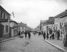 Folkliv Kungsgatan, Enköping, sett ungefär från korsningen med Rådhusgatan, mot sydväst.