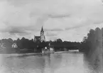 Sunne kyrka med Sunsbron i förgrunden en ångbåt.