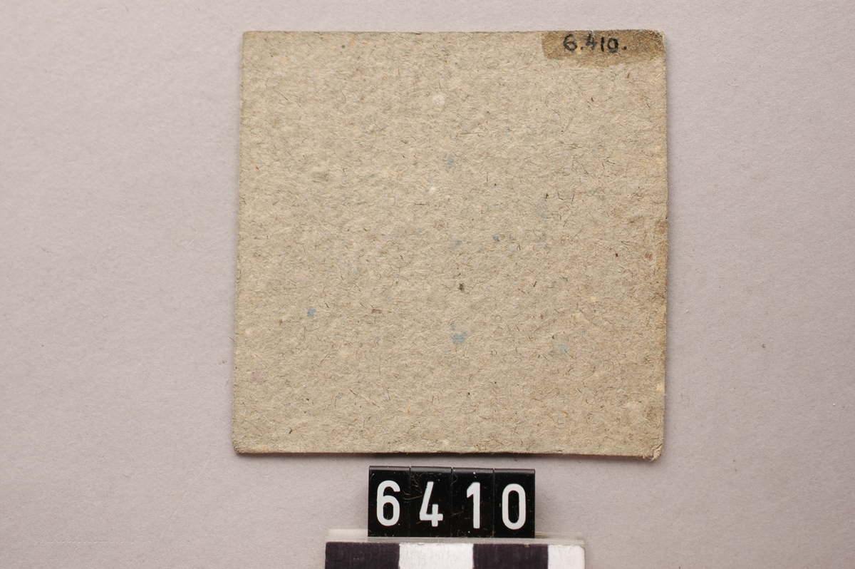 Tre kolpolletter av papp, kvadratiska med bokstaven B. i blått tryck.