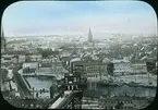 Kolorerad skioptikonbild,  panorama vy över Stockholm, sett från Mosebacke. Strax nedanför syns Katarinahissen.