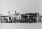 Turistsällskap i alphydda (värdshus) i Davos i Schweiz 1890. Mannen på taket med tuben är dir. Carl Ångström från Motala.