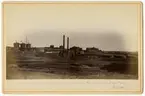 Överblick över  aktiebolaget Bröderna Nobels petroleumfabrik. Baku 1883. (Mer text finns på baksidan av fotografiet).
Fotografiet finns i röd kartong med texten -  Bilder från några anläggingar inom Nafta-Produktionsaktiebolag Bröderna Nobel.