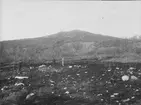 Malmletning syd väst om Loussavaara, september 1918. Observatör och handtlangare med varsin räknestav. Den andra handtlangaren bär stickor, som ska markera punkten i ekvipotentiallinjen. Omedelbart bakom personalen synes den ena linjeelektroden.