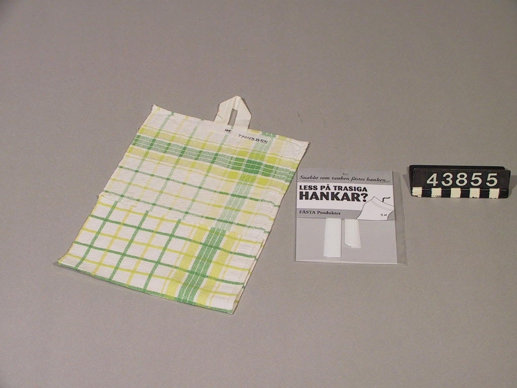 Handdukshank av bomullsband, avsedd att fästas på handduk.