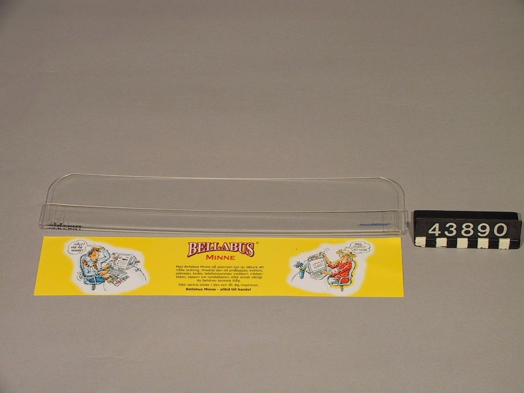 En transparent ficka som fästs på datorskärmens övre del, förvaring för papperslappar.