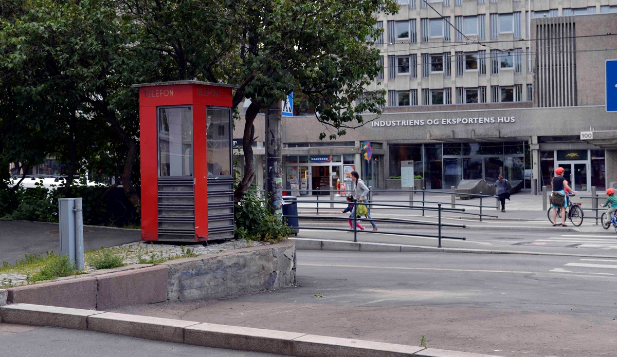 This is the story of how Norway’s most important conversation-space was designed by a young, freshly graduated man from Bergen.

“Norwegian architects are hereby invited…”
In the autumn of 1932, Oslo Telefonanlegginitiated an architectural competition. Finally, Oslo would get its own telephone booth. The city had had so called “talking-stations” from 1885, which in turn were overtaken by automatic telephones 
 only available at selected Narvesen kiosks. The state 
was of the opinion that now was the time to offer the public a better service; public telephone booths open 24/7, like the ones they already had in Sweden and England. But what would they look like, these new telephone booths? What considerations would it
 be necessary to take when designing it? The telegraph board developed a detailed list of demands and restraints: “The booth is intended to be placed outside on the streets and squares and need to be designed so that snow and ice does not hinder the opening and closing of the doors,” they wrote. “To prevent vandalism, theft, uncleanliness etc. inside the booth, it needs to be designed so that from all angles one may see what is going on in there.” Additionally, it would need to withstand storms and bad weather, and “preferably also being whipped by rain mixed with seawater” 

This was not all: The appearance would have to be «pleasing». The booth also needed to be movable, so that it could be taken in to be serviced at Telegrafverket’s main workshops. The reqired material was iron, and the surface was to be spray painted  preferably using car-body paint. There was a requirement for “a writing shelf, a pack shelf, and a suitable place for the telephone catalogue.” Also, there would need to be an illuminated TELEFON  sign, easily visible from all four angles. The total cost for each booth should not exceed 1000 kroner. The first prize for coming up with such a product was 800 kroner.

“Norwegianarchitects are hereby invited to partake in a competition for the design of a telephone booth…”  

The man with the solution
«At some point in 1932, Georg Fredrik sat at a party in Bergen. Maybe he felt a bit lost and forgotten as he often had throughout his life. He retreated to a quiet corner, took out a pencil and strted doodling on a matchbox.  According to my mother, this was how the telephone booth came into being.” In the book “Norges lille røde  historien om telefonkiosken,” Lars Fasting describes his father, the man who is far less known than the iconic architctural structure he left behind. Georg Fredrik Fasting was from Bergen, born into a family of working people and smallholders. One unusual facet of Georg Fredrik was that he was born without ears. His mother made sure he learnt to speak, read and write, 
ut Lars Fasting indicates that his father would seek refuge in drawing when the social challenges became too much to bear. And in the end drawing became his profession. In 1924 he secured a guarantor for a student loan, and started studying to become an a
rchitect at the NTH. Throughout the 1930s he entered several architectural competitions, with drafts produced, according to his son, “after work and in the late hours of the night.”

His efforts were not wasted. Out of 93 entries, with names such as “Flirt”, “Brrr”, “Ring” and “Amor”, the jury selected Fasting’s submission, “RIKS” as the new telephone booth: “The draft shows a strikingly simple solution to the task, technically as well as aesthetically well worked out.”

Taut and provident
Simple and aesthetc are the keywords here. Fasting had designed a booth pointing towards the future, and to modernism. Just how modern it was can be seen by comparing RIKS to the British telephone booth, also designed in the interwar-era. While the British version with it classicistic style is looking back to the heyday of the empire, Fasting’s booth is progressive and functionalistic. Like most Norwegian architects, Fasting broke with the classicistic style of architecture after the Stockholm-exhibition in 1930. “After it, almost all buildings erected in Norway until the German invasion in 1940, were in the functionalistic architectural style,” writes senior curator of architecture at the Norwegian National Museum, Ulf Grønvold, in the book, “Den lille røde”.“TheNorwegian booth is a piece of functionalistic architecture, an asymmetric composition with its roof slab overhanging the word TELEFON, in bold sans seraph lettering,”concludes Ulf Grønvold.

Fashionably red
And it was red. Fasting chose a colour which was part of the modern palette. “A bright red colour, but not as shiny as a signal red, the character of the colour places it among the fashionable colours within functionalism,” states paintings conservator and researcher in NIKU (Norwegian Institute for Cultural Heitage Research), Jon Brænne. In his opinion, Fasting went for visibility without making the booth stand out too much from its surroundings. The original colour was in use up to around 1950, when it changed to signal red. Towards the end of the 1970s the clour was again adjusted towards today’s orangey red.

The design, however, has not changed. RIKS is eighty years and still looks remarkably good. That’s what makes Fasting’s telephone booth a classic  even before it was added to DOCOMOMO’s list over moden icons of design. For Telenor, the telephone booth has served as a pathway into the hearts of the public. For many, Telenor (Televerket) was synonymous with exactly this telephone booth, because this was where one would go to place a call. Having a home
phone was not common until the 1980s. As such the red box became part of the Norwegian everyday and consciousness. The symbol- and publicity value of this is hard to evaluate, but in 2007 it was time to give honour where honour was due, Telenor, in consul
tation with the Directorate for Cultural Heritage, decided to preserve 100 telephone booths for all eternity.

And what about Georg Fredrik Fasting? What happened to him? At the age of 56 an entry in his diary states: «I CAN HEAR». As the first person in th world he had undergone an operation where he had ear canals constructed and eardrums fitted. For the rest of his life, the man behind Norway’s own telephone booth could answer the telephone himself.

Source: Norges lille røde historien om telefonkiosken (2007), issued by The Norwegian Telecom Museum and Telenor Cultural Heritage.