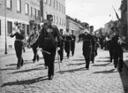 Jubileum 50 års, A 6. Musikkåren, på väg genom staden.
