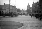 Motorklubben 1924 ett antal bilar mellan tullhuset och centralstationen Kontinentgatan, en stor folksamling framför centralen posten i bakgrunden.
	Metallutfällning, fingeravtryck, missfärgad rosa.