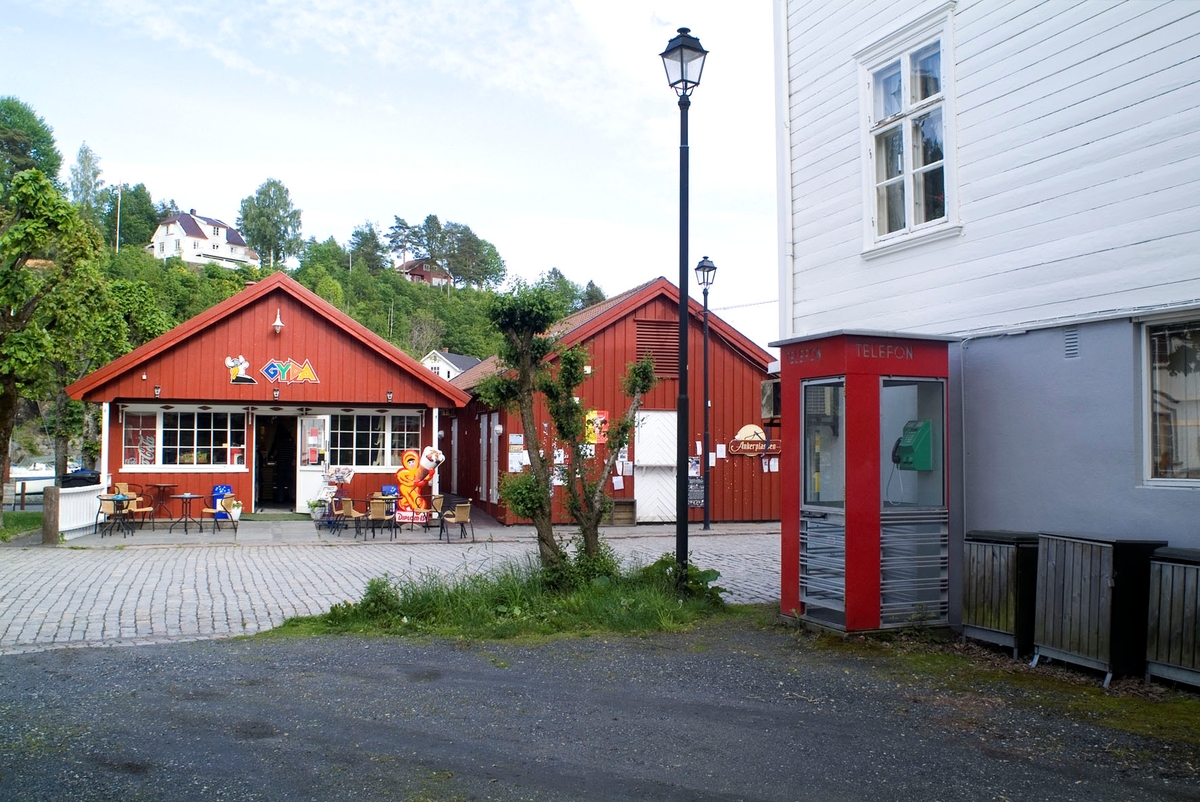 This is the story of how Norway’s most important conversation-space was designed by a young, freshly graduated man from Bergen.

“Norwegian architects are hereby invited…”
In the autumn of 1932, Oslo Telefonanlegginitiated an architectural competition. Finally, Oslo would get its own telephone booth. The city had had so called “talking-stations” from 1885, which in turn were overtaken by automatic telephones 
 only available at selected Narvesen kiosks. The state 
was of the opinion that now was the time to offer the public a better service; public telephone booths open 24/7, like the ones they already had in Sweden and England. But what would they look like, these new telephone booths? What considerations would it
 be necessary to take when designing it? The telegraph board developed a detailed list of demands and restraints: “The booth is intended to be placed outside on the streets and squares and need to be designed so that snow and ice does not hinder the opening and closing of the doors,” they wrote. “To prevent vandalism, theft, uncleanliness etc. inside the booth, it needs to be designed so that from all angles one may see what is going on in there.” Additionally, it would need to withstand storms and bad weather, and “preferably also being whipped by rain mixed with seawater” 

This was not all: The appearance would have to be «pleasing». The booth also needed to be movable, so that it could be taken in to be serviced at Telegrafverket’s main workshops. The reqired material was iron, and the surface was to be spray painted  preferably using car-body paint. There was a requirement for “a writing shelf, a pack shelf, and a suitable place for the telephone catalogue.” Also, there would need to be an illuminated TELEFON  sign, easily visible from all four angles. The total cost for each booth should not exceed 1000 kroner. The first prize for coming up with such a product was 800 kroner.

“Norwegianarchitects are hereby invited to partake in a competition for the design of a telephone booth…”  

The man with the solution
«At some point in 1932, Georg Fredrik sat at a party in Bergen. Maybe he felt a bit lost and forgotten as he often had throughout his life. He retreated to a quiet corner, took out a pencil and strted doodling on a matchbox.  According to my mother, this was how the telephone booth came into being.” In the book “Norges lille røde  historien om telefonkiosken,” Lars Fasting describes his father, the man who is far less known than the iconic architctural structure he left behind. Georg Fredrik Fasting was from Bergen, born into a family of working people and smallholders. One unusual facet of Georg Fredrik was that he was born without ears. His mother made sure he learnt to speak, read and write, 
ut Lars Fasting indicates that his father would seek refuge in drawing when the social challenges became too much to bear. And in the end drawing became his profession. In 1924 he secured a guarantor for a student loan, and started studying to become an a
rchitect at the NTH. Throughout the 1930s he entered several architectural competitions, with drafts produced, according to his son, “after work and in the late hours of the night.”

His efforts were not wasted. Out of 93 entries, with names such as “Flirt”, “Brrr”, “Ring” and “Amor”, the jury selected Fasting’s submission, “RIKS” as the new telephone booth: “The draft shows a strikingly simple solution to the task, technically as well as aesthetically well worked out.”

Taut and provident
Simple and aesthetc are the keywords here. Fasting had designed a booth pointing towards the future, and to modernism. Just how modern it was can be seen by comparing RIKS to the British telephone booth, also designed in the interwar-era. While the British version with it classicistic style is looking back to the heyday of the empire, Fasting’s booth is progressive and functionalistic. Like most Norwegian architects, Fasting broke with the classicistic style of architecture after the Stockholm-exhibition in 1930. “After it, almost all buildings erected in Norway until the German invasion in 1940, were in the functionalistic architectural style,” writes senior curator of architecture at the Norwegian National Museum, Ulf Grønvold, in the book, “Den lille røde”.“TheNorwegian booth is a piece of functionalistic architecture, an asymmetric composition with its roof slab overhanging the word TELEFON, in bold sans seraph lettering,”concludes Ulf Grønvold.

Fashionably red
And it was red. Fasting chose a colour which was part of the modern palette. “A bright red colour, but not as shiny as a signal red, the character of the colour places it among the fashionable colours within functionalism,” states paintings conservator and researcher in NIKU (Norwegian Institute for Cultural Heitage Research), Jon Brænne. In his opinion, Fasting went for visibility without making the booth stand out too much from its surroundings. The original colour was in use up to around 1950, when it changed to signal red. Towards the end of the 1970s the clour was again adjusted towards today’s orangey red.

The design, however, has not changed. RIKS is eighty years and still looks remarkably good. That’s what makes Fasting’s telephone booth a classic  even before it was added to DOCOMOMO’s list over moden icons of design. For Telenor, the telephone booth has served as a pathway into the hearts of the public. For many, Telenor (Televerket) was synonymous with exactly this telephone booth, because this was where one would go to place a call. Having a home
phone was not common until the 1980s. As such the red box became part of the Norwegian everyday and consciousness. The symbol- and publicity value of this is hard to evaluate, but in 2007 it was time to give honour where honour was due, Telenor, in consul
tation with the Directorate for Cultural Heritage, decided to preserve 100 telephone booths for all eternity.

And what about Georg Fredrik Fasting? What happened to him? At the age of 56 an entry in his diary states: «I CAN HEAR». As the first person in th world he had undergone an operation where he had ear canals constructed and eardrums fitted. For the rest of his life, the man behind Norway’s own telephone booth could answer the telephone himself.

Source: Norges lille røde historien om telefonkiosken (2007), issued by The Norwegian Telecom Museum and Telenor Cultural Heritage.