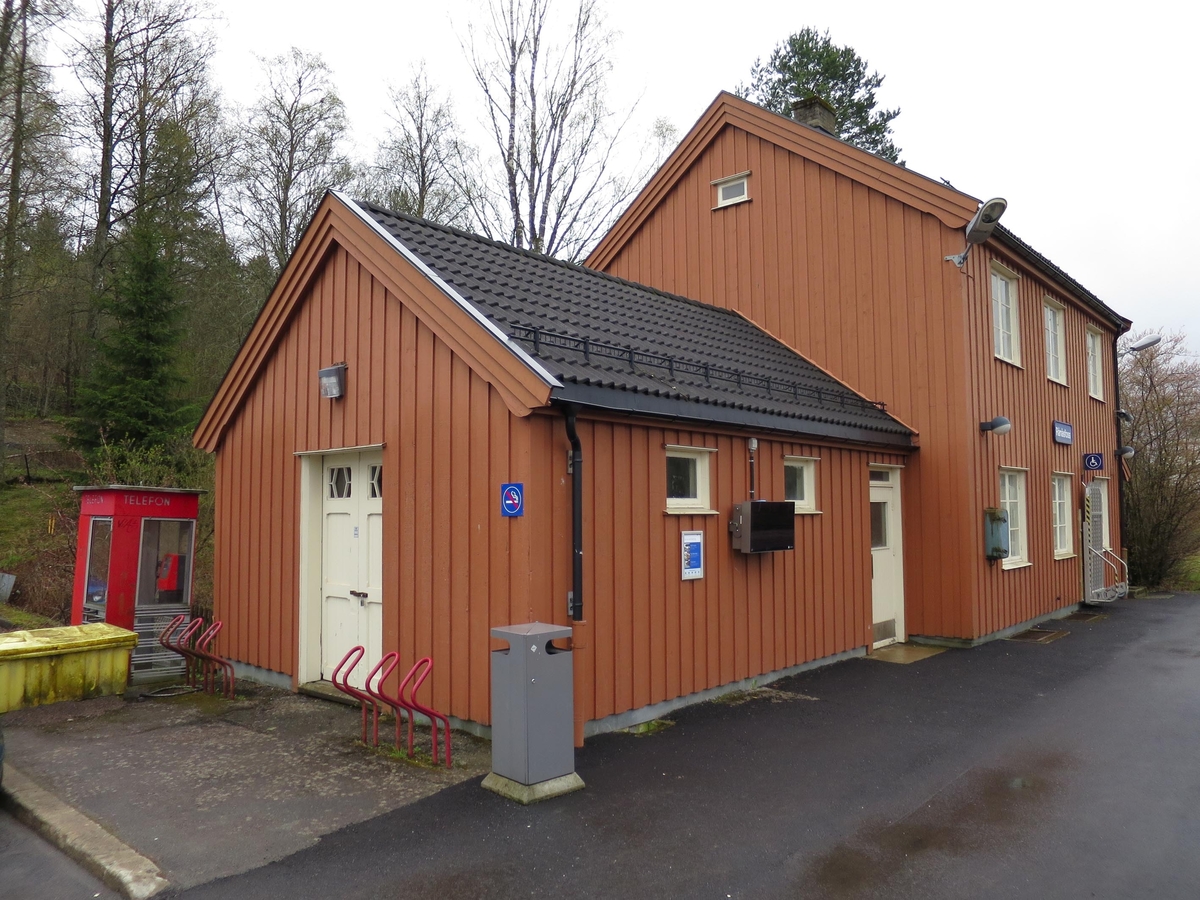 This is the story of how Norway’s most important conversation-space was designed by a young, freshly graduated man from Bergen.

“Norwegian architects are hereby invited…”
In the autumn of 1932, Oslo Telefonanlegginitiated an architectural competition. Finally, Oslo would get its own telephone booth. The city had had so called “talking-stations” from 1885, which in turn were overtaken by automatic telephones 
 only available at selected Narvesen kiosks. The state 
was of the opinion that now was the time to offer the public a better service; public telephone booths open 24/7, like the ones they already had in Sweden and England. But what would they look like, these new telephone booths? What considerations would it
 be necessary to take when designing it? The telegraph board developed a detailed list of demands and restraints: “The booth is intended to be placed outside on the streets and squares and need to be designed so that snow and ice does not hinder the opening and closing of the doors,” they wrote. “To prevent vandalism, theft, uncleanliness etc. inside the booth, it needs to be designed so that from all angles one may see what is going on in there.” Additionally, it would need to withstand storms and bad weather, and “preferably also being whipped by rain mixed with seawater” 

This was not all: The appearance would have to be «pleasing». The booth also needed to be movable, so that it could be taken in to be serviced at Telegrafverket’s main workshops. The reqired material was iron, and the surface was to be spray painted  preferably using car-body paint. There was a requirement for “a writing shelf, a pack shelf, and a suitable place for the telephone catalogue.” Also, there would need to be an illuminated TELEFON  sign, easily visible from all four angles. The total cost for each booth should not exceed 1000 kroner. The first prize for coming up with such a product was 800 kroner.

“Norwegianarchitects are hereby invited to partake in a competition for the design of a telephone booth…”  

The man with the solution
«At some point in 1932, Georg Fredrik sat at a party in Bergen. Maybe he felt a bit lost and forgotten as he often had throughout his life. He retreated to a quiet corner, took out a pencil and strted doodling on a matchbox.  According to my mother, this was how the telephone booth came into being.” In the book “Norges lille røde  historien om telefonkiosken,” Lars Fasting describes his father, the man who is far less known than the iconic architctural structure he left behind. Georg Fredrik Fasting was from Bergen, born into a family of working people and smallholders. One unusual facet of Georg Fredrik was that he was born without ears. His mother made sure he learnt to speak, read and write, 
ut Lars Fasting indicates that his father would seek refuge in drawing when the social challenges became too much to bear. And in the end drawing became his profession. In 1924 he secured a guarantor for a student loan, and started studying to become an a
rchitect at the NTH. Throughout the 1930s he entered several architectural competitions, with drafts produced, according to his son, “after work and in the late hours of the night.”

His efforts were not wasted. Out of 93 entries, with names such as “Flirt”, “Brrr”, “Ring” and “Amor”, the jury selected Fasting’s submission, “RIKS” as the new telephone booth: “The draft shows a strikingly simple solution to the task, technically as well as aesthetically well worked out.”

Taut and provident
Simple and aesthetc are the keywords here. Fasting had designed a booth pointing towards the future, and to modernism. Just how modern it was can be seen by comparing RIKS to the British telephone booth, also designed in the interwar-era. While the British version with it classicistic style is looking back to the heyday of the empire, Fasting’s booth is progressive and functionalistic. Like most Norwegian architects, Fasting broke with the classicistic style of architecture after the Stockholm-exhibition in 1930. “After it, almost all buildings erected in Norway until the German invasion in 1940, were in the functionalistic architectural style,” writes senior curator of architecture at the Norwegian National Museum, Ulf Grønvold, in the book, “Den lille røde”.“TheNorwegian booth is a piece of functionalistic architecture, an asymmetric composition with its roof slab overhanging the word TELEFON, in bold sans seraph lettering,”concludes Ulf Grønvold.

Fashionably red
And it was red. Fasting chose a colour which was part of the modern palette. “A bright red colour, but not as shiny as a signal red, the character of the colour places it among the fashionable colours within functionalism,” states paintings conservator and researcher in NIKU (Norwegian Institute for Cultural Heitage Research), Jon Brænne. In his opinion, Fasting went for visibility without making the booth stand out too much from its surroundings. The original colour was in use up to around 1950, when it changed to signal red. Towards the end of the 1970s the clour was again adjusted towards today’s orangey red.

The design, however, has not changed. RIKS is eighty years and still looks remarkably good. That’s what makes Fasting’s telephone booth a classic  even before it was added to DOCOMOMO’s list over moden icons of design. For Telenor, the telephone booth has served as a pathway into the hearts of the public. For many, Telenor (Televerket) was synonymous with exactly this telephone booth, because this was where one would go to place a call. Having a home
phone was not common until the 1980s. As such the red box became part of the Norwegian everyday and consciousness. The symbol- and publicity value of this is hard to evaluate, but in 2007 it was time to give honour where honour was due, Telenor, in consul
tation with the Directorate for Cultural Heritage, decided to preserve 100 telephone booths for all eternity.

And what about Georg Fredrik Fasting? What happened to him? At the age of 56 an entry in his diary states: «I CAN HEAR». As the first person in th world he had undergone an operation where he had ear canals constructed and eardrums fitted. For the rest of his life, the man behind Norway’s own telephone booth could answer the telephone himself.

Source: Norges lille røde historien om telefonkiosken (2007), issued by The Norwegian Telecom Museum and Telenor Cultural Heritage.