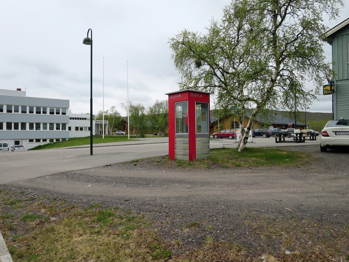 This is the story of how Norway’s most important conversation-space was designed by a young, freshly graduated man from Bergen.

“Norwegian architects are hereby invited…”
In the autumn of 1932, Oslo Telefonanlegginitiated an architectural competition. Finally, Oslo would get its own telephone booth. The city had had so called “talking-stations” from 1885, which in turn were overtaken by automatic telephones 
 only available at selected Narvesen kiosks. The state 
was of the opinion that now was the time to offer the public a better service; public telephone booths open 24/7, like the ones they already had in Sweden and England. But what would they look like, these new telephone booths? What considerations would it
 be necessary to take when designing it? The telegraph board developed a detailed list of demands and restraints: “The booth is intended to be placed outside on the streets and squares and need to be designed so that snow and ice does not hinder the opening and closing of the doors,” they wrote. “To prevent vandalism, theft, uncleanliness etc. inside the booth, it needs to be designed so that from all angles one may see what is going on in there.” Additionally, it would need to withstand storms and bad weather, and “preferably also being whipped by rain mixed with seawater” 

This was not all: The appearance would have to be «pleasing». The booth also needed to be movable, so that it could be taken in to be serviced at Telegrafverket’s main workshops. The reqired material was iron, and the surface was to be spray painted  preferably using car-body paint. There was a requirement for “a writing shelf, a pack shelf, and a suitable place for the telephone catalogue.” Also, there would need to be an illuminated TELEFON  sign, easily visible from all four angles. The total cost for each booth should not exceed 1000 kroner. The first prize for coming up with such a product was 800 kroner.

“Norwegianarchitects are hereby invited to partake in a competition for the design of a telephone booth…”  

The man with the solution
«At some point in 1932, Georg Fredrik sat at a party in Bergen. Maybe he felt a bit lost and forgotten as he often had throughout his life. He retreated to a quiet corner, took out a pencil and strted doodling on a matchbox.  According to my mother, this was how the telephone booth came into being.” In the book “Norges lille røde  historien om telefonkiosken,” Lars Fasting describes his father, the man who is far less known than the iconic architctural structure he left behind. Georg Fredrik Fasting was from Bergen, born into a family of working people and smallholders. One unusual facet of Georg Fredrik was that he was born without ears. His mother made sure he learnt to speak, read and write, 
ut Lars Fasting indicates that his father would seek refuge in drawing when the social challenges became too much to bear. And in the end drawing became his profession. In 1924 he secured a guarantor for a student loan, and started studying to become an a
rchitect at the NTH. Throughout the 1930s he entered several architectural competitions, with drafts produced, according to his son, “after work and in the late hours of the night.”

His efforts were not wasted. Out of 93 entries, with names such as “Flirt”, “Brrr”, “Ring” and “Amor”, the jury selected Fasting’s submission, “RIKS” as the new telephone booth: “The draft shows a strikingly simple solution to the task, technically as well as aesthetically well worked out.”

Taut and provident
Simple and aesthetc are the keywords here. Fasting had designed a booth pointing towards the future, and to modernism. Just how modern it was can be seen by comparing RIKS to the British telephone booth, also designed in the interwar-era. While the British version with it classicistic style is looking back to the heyday of the empire, Fasting’s booth is progressive and functionalistic. Like most Norwegian architects, Fasting broke with the classicistic style of architecture after the Stockholm-exhibition in 1930. “After it, almost all buildings erected in Norway until the German invasion in 1940, were in the functionalistic architectural style,” writes senior curator of architecture at the Norwegian National Museum, Ulf Grønvold, in the book, “Den lille røde”.“TheNorwegian booth is a piece of functionalistic architecture, an asymmetric composition with its roof slab overhanging the word TELEFON, in bold sans seraph lettering,”concludes Ulf Grønvold.

Fashionably red
And it was red. Fasting chose a colour which was part of the modern palette. “A bright red colour, but not as shiny as a signal red, the character of the colour places it among the fashionable colours within functionalism,” states paintings conservator and researcher in NIKU (Norwegian Institute for Cultural Heitage Research), Jon Brænne. In his opinion, Fasting went for visibility without making the booth stand out too much from its surroundings. The original colour was in use up to around 1950, when it changed to signal red. Towards the end of the 1970s the clour was again adjusted towards today’s orangey red.

The design, however, has not changed. RIKS is eighty years and still looks remarkably good. That’s what makes Fasting’s telephone booth a classic  even before it was added to DOCOMOMO’s list over moden icons of design. For Telenor, the telephone booth has served as a pathway into the hearts of the public. For many, Telenor (Televerket) was synonymous with exactly this telephone booth, because this was where one would go to place a call. Having a home
phone was not common until the 1980s. As such the red box became part of the Norwegian everyday and consciousness. The symbol- and publicity value of this is hard to evaluate, but in 2007 it was time to give honour where honour was due, Telenor, in consul
tation with the Directorate for Cultural Heritage, decided to preserve 100 telephone booths for all eternity.

And what about Georg Fredrik Fasting? What happened to him? At the age of 56 an entry in his diary states: «I CAN HEAR». As the first person in th world he had undergone an operation where he had ear canals constructed and eardrums fitted. For the rest of his life, the man behind Norway’s own telephone booth could answer the telephone himself.

Source: Norges lille røde historien om telefonkiosken (2007), issued by The Norwegian Telecom Museum and Telenor Cultural Heritage.