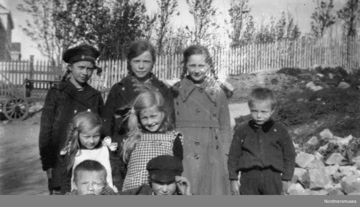 En gruppe barn. Trolig er noen av disse fra Rød familien, som bodde i Storgata på Kirkelandet i Kristiansund. Fotograf er sannsynligvis et medlem fra Rød familien. Ukjent datering, trolig mellom 1930 til 1939. Giver av bildet er Turid Rød. Fra Nordmøre Museums fotosamlinger. Reg: EFR
