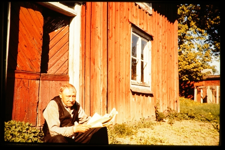 Tidningsläsning på trappan. Sent 1950-tal.