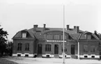 En folkskola av tegel, med flaggstång på skolgården.
Lekaryds skola.