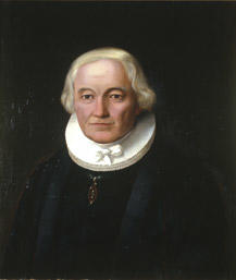 Portrett av Grøgaard (Grøgård). Prestekjole og -krave. Medalje i grønt bånd om halsen.