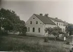 Påskallaviks herrgård sedd från trädgården. Det är ett putsat timmerhus, byggt cirka 1858 sedan ett äldre hus brunnit ned. Det byggdes om hely 1928. Numera är det ombyggt till lägenheter.