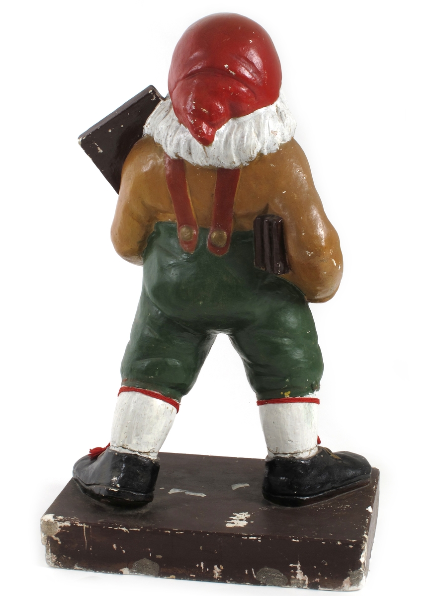 Julenisse med sjokoladeplate på venstre arm.