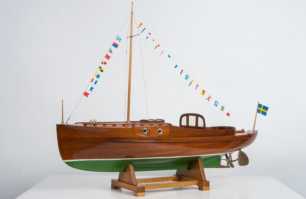 Helmodell av motorbåten WIKING X. Skrov av fernissad mahogny med grömålad botten, mässingsdetaljer. Skrå av ek.