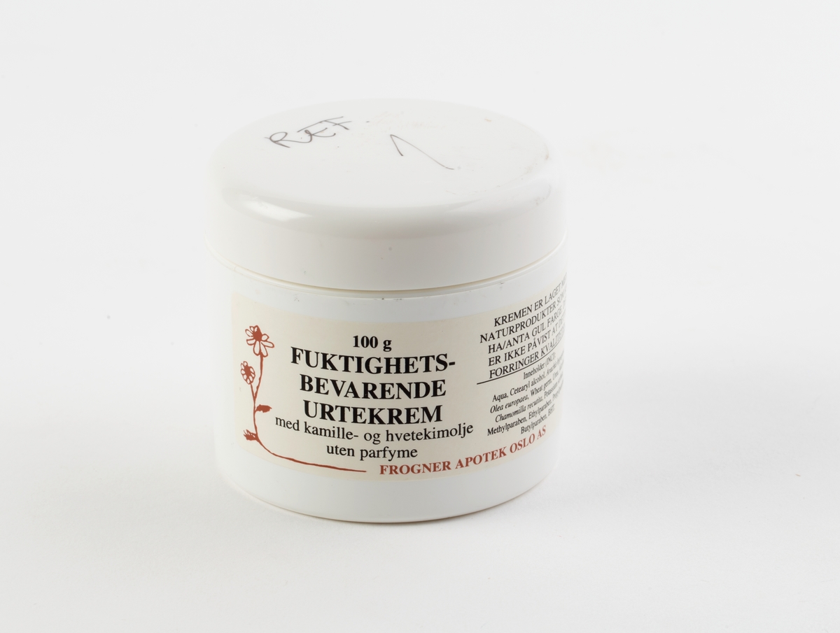 Hvit salvekrukke med skrulokk. Inneholder krem.  Tegning av ringblomst og deklarasjon av innhold er trykket på krukken.