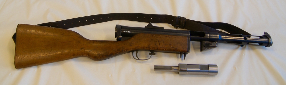 Maskinpistol med bærestropp og lyddemper.