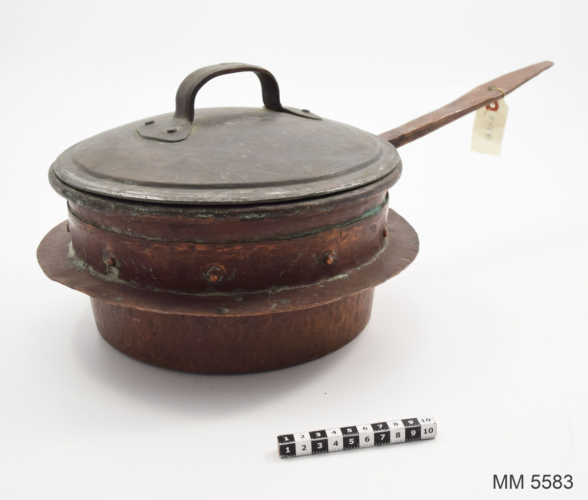 Panna av koppar. Nitad. Har tillhört korvetten Norrköping. Märkt: Tre kronstämplar. Locket är märkt med tre kronstämplar samt SIGURD.