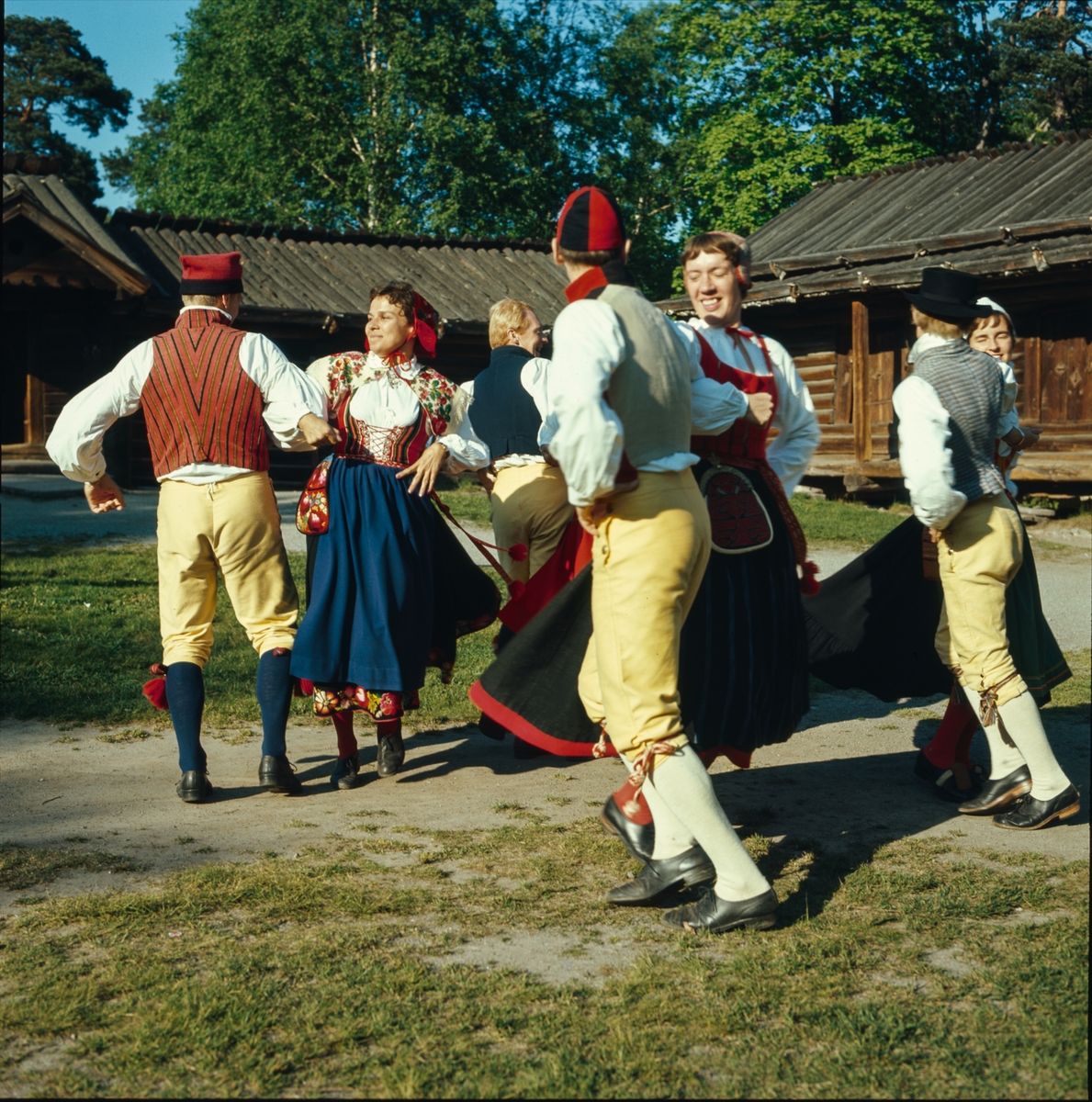 Ett folkdanslag dansar på Moragårdens gårdsplan.