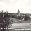 Gladhammar kyrka: Kyrkan sedd från gravfältet och berget.