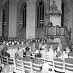 Skara. Lottakårens 25-årsjubileum 1954. Högtidlighet i Skara Domkyrka.