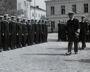 Uppställning av värnpliktiga på Sparres kaserngård. Framför dem går konteramiral Samuelson med en kommendör, båda iklädda i uniform.