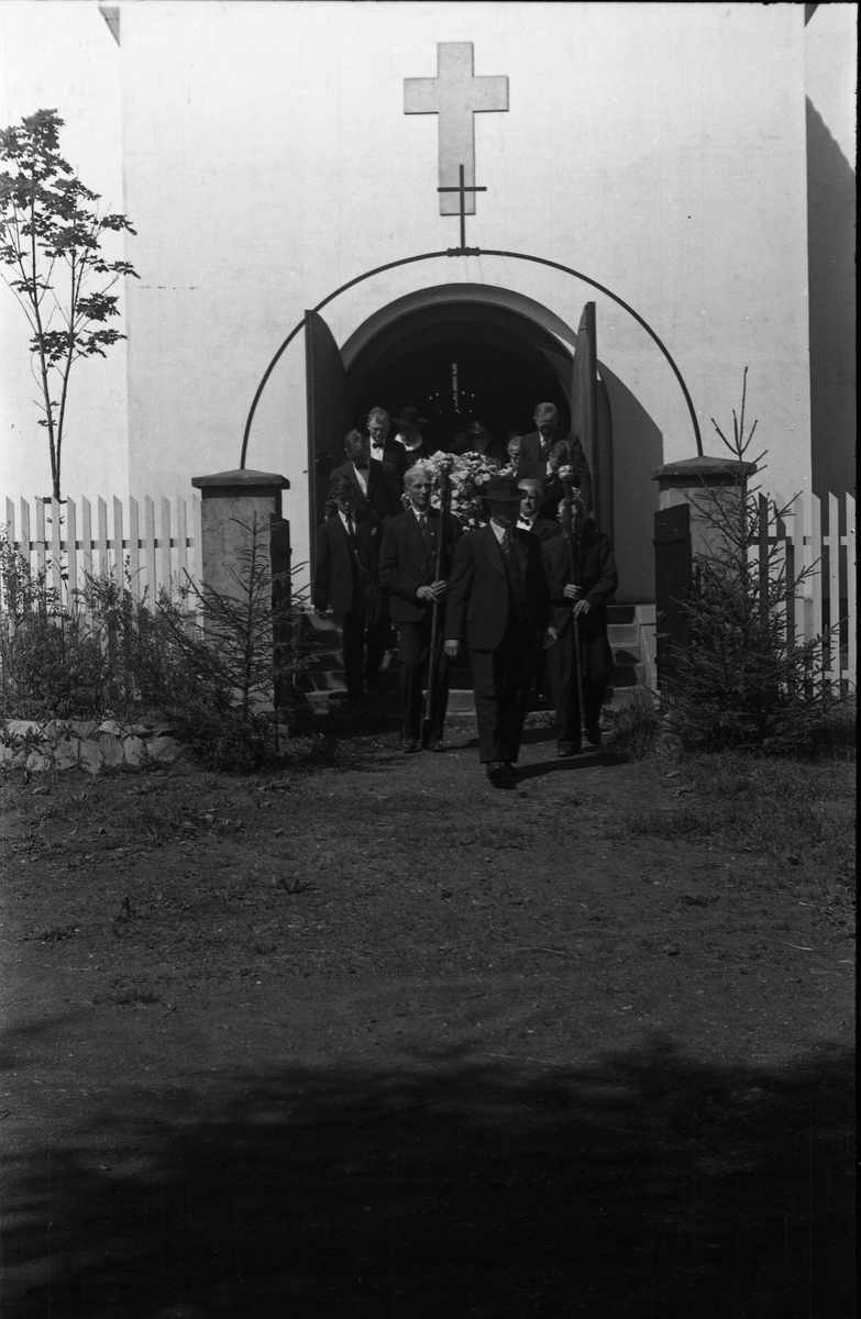 Fra en begravelse ved Hoff kirke. Serie på åtte bilder fra kisten bæres ut fra gravkapellet, og på kirkegården.