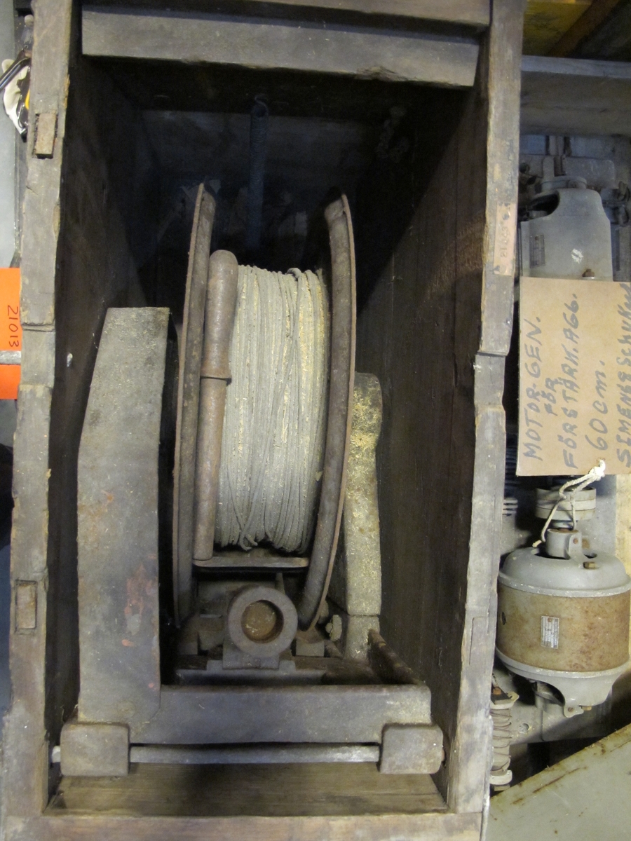 Motorgenerator för förstärkningsaggregat. 
Rektangulär huv med ventilspringa onder lockets kant. Bottenplatta med två cylindriska motorer.