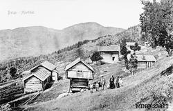 Familie foran gardstun i Berge i Hjartdal