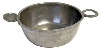 Skål av tenn med handtag i form av snäcka och godronnerad ring.