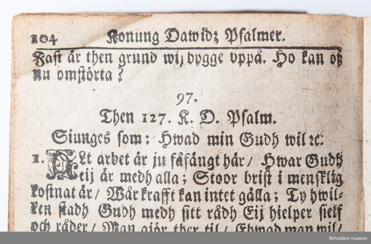 Psalmbok, frakturstil, linnelumppapper, svenska, 403 sidor samt register, duodecimo (12:o). 1695 års psalmbok, 413 psalmer. Trasig.
Samtida helfranskt skinnband med fem lätt upphöjda bind, pärmfyllnad av trä. Skinnet präglat i dekorativt mönster, liknande på fram- och baksida. Dekortivt ramverk, i övrigt heltäckande dekor med textband på mitten, oläsligt. 
Denna slags inbindning användes gärna då psalmboken skänktes som trolovningsgåva.
Rester av två bokpärmsbeslag; fragmentariska skinnband och metallspänne på det nedre. Främre pärmen lagad längs del av de båda kortsidorna med hamrat kopparband, bakre pärmen har hamrat kopparband nertill på kortsidan.
På första sidan handanteckning med uppgifter om ägare och årtalet 1735.

Psalmboken sammanbunden med evangelie- och epistelbok; Evangelia och epistler, 274 sidor.
Cib