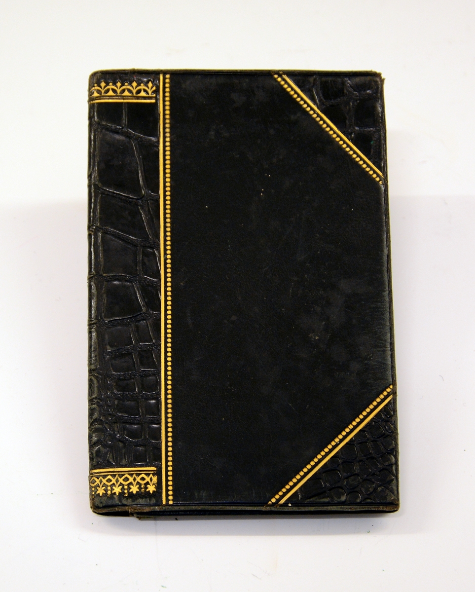 Liten lommebok i grønt skinn med to rom, mosegrønt fôr. Utsiden med preget dekorrender i gull. En side mangler sømmen.
Innlagt konvolutt med to resepter fra Henrik Ibsens privatlege, Dr. med. Edvard Bull. Den ene resepten datert 14/3 1903. En tredje resept, italiensk, datert 31. mai 1897.