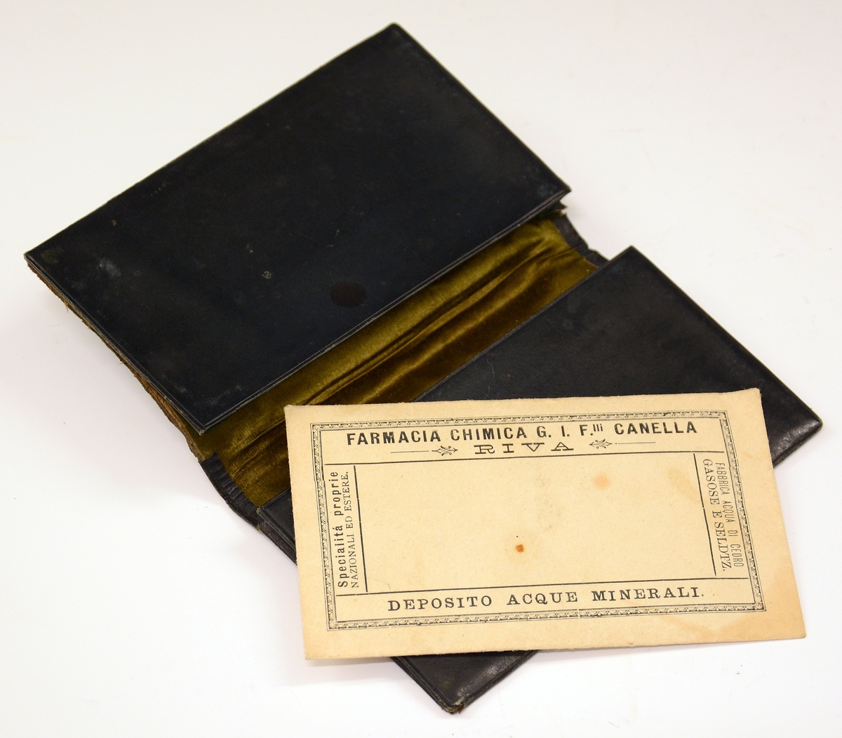 Liten lommebok i grønt skinn med to rom, mosegrønt fôr. Utsiden med preget dekorrender i gull. En side mangler sømmen.
Innlagt konvolutt med to resepter fra Henrik Ibsens privatlege, Dr. med. Edvard Bull. Den ene resepten datert 14/3 1903. En tredje resept, italiensk, datert 31. mai 1897.