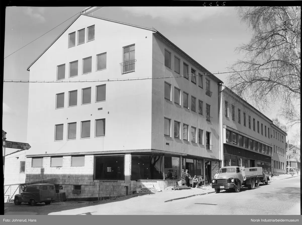 Butikklokale i Storgata 66. Arbeidsmenn er oppstilt ved trappen inn til lokalet. Lastebil foran butikken.