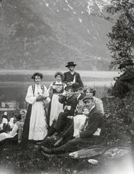 Festkledde folk drikk kaffi i naturen på 17. mai.