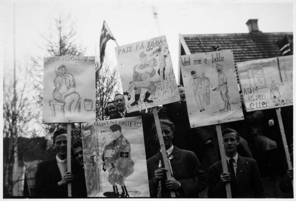 Frigjøringsdagen. Ungdom med plakater på skoleplassen. "Quisling dimiteres"