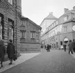 Del av Tanneforsgatan i Linköping 1968. En nutida betraktare känner igen sig i det mesta förutom trähuset i blickfånget, som en tid efter fototillfället revs för att ge plats för ett modernt affärshus. Vy mot väster.