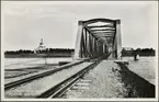 Järnvägsbron över Torneälven mellan Haparanda och Torneå med Alitornio kyrka i bakgrunden.