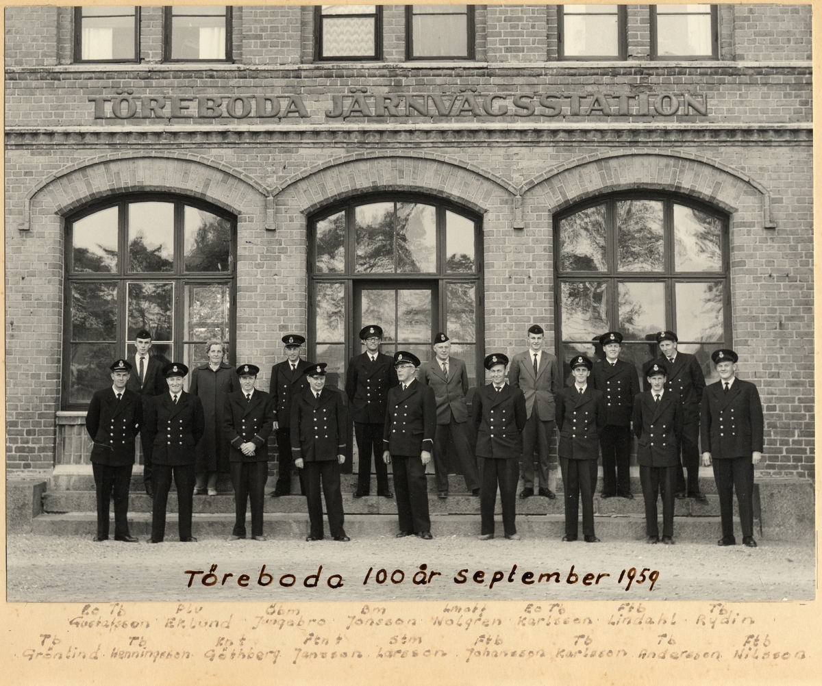 Töreboda stationshus med 17 st personal framför. Töreboda 100 år september 1959. Från vänster: Tb Bo Gustafsson, Plv Eklund, Ögm Jungsbro, Bm Jonsson, ? Wolgren, Tb E. O. Karlson, Ftb Lindahl, Tb Rydin.
Främre raden från vänster: Tb Grönlind, Tb Henningsson, Knt Göthberg, Fknt Göthberg, Fknt Jansson, Stm Larsson, Ftb Johansson, Tb Karlsson, Tb Andersson, Ftb Nilsson. Tb = Trafikbiträde, Plv = Platsvakt, Knt = Kontorist, Fknt = Förste Kontorist, Stm = Stationsmästare