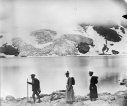 Fire fjellvandrere ved et vann, Jotunheimen