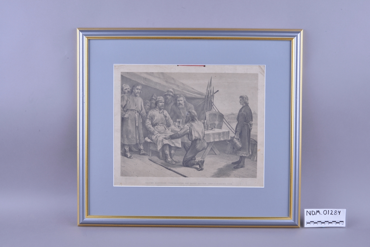 Rektangulær plansje av hvitt papir festet på kartong. Motivet er rektangulært og sentrert midt på plansjen. Motivet er trykt i svart- hvitt. Det er trykt skrift i svart midt på under motivet, og i øvre høyre og venstre hjørne under motivet. Plansjen er innrammet. Rammen er av tre med grå-, hvit- og gullfarget maling. Glass og grått passepartout. To hull med innsatt metallring øverst midt på plansjen. En rødt bånd av tekstil er trukket gjennom hullene.