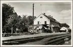 Spårsida av station med pressbyråns kiosk i bild.