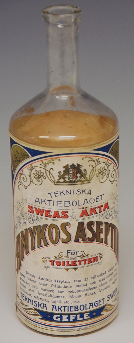 Glasflaska. 
Etikett med text; 
Tekniska aktiebolaget
Sweas Äkta
Amyktos-Aseptin. 
För toiletten.